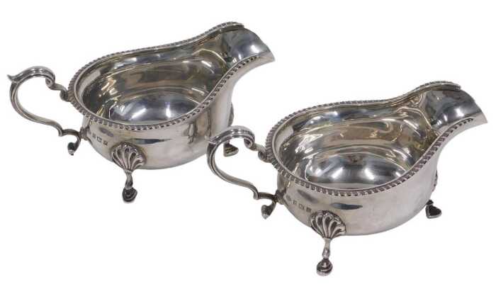 A pair of Elizabeth II silver sauce boats, each with ear handles and triple hoof feet, by Adie...