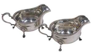 A pair of Elizabeth II silver sauce boats, each with ear handles and triple hoof feet, by Adie...