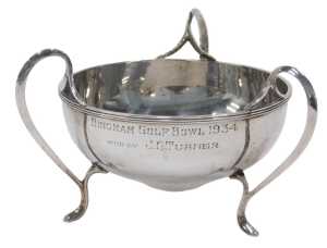 A George V silver three handled bowl, of shaped circular form, on hoof feet, marked Bingham Golf...