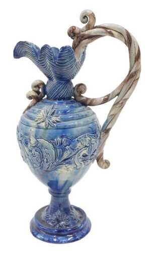 A late 19thC Majolica style Castle Hedingham pottery ewer, with shaped spout, entwined handle,...