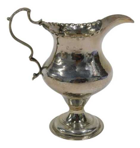 A George III silver cream jug, with plain spout, flared rim, acanthus leaf ear shaped handle,...