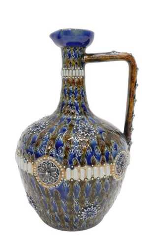 An early 20thC Doulton Lambeth stoneware ewer, with beak spout, angular handle, cylindrical stem...