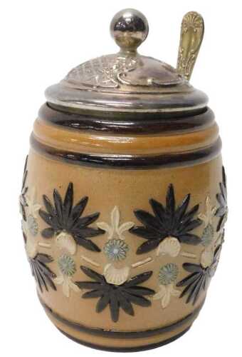 An early 20thC Doulton Lambeth preserve jar, of barrel form, raised with floral rosettes, with...