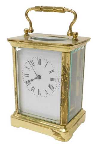 An early 20thC brass carriage clock, of rectangular form, the 6cm wide Roman numeric dial...