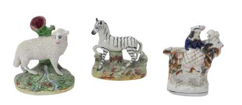 A 19thC Staffordshire pottery figure of a zebra, in naturalistic setting, 12cm high, a...