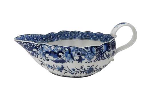 An 18thC English porcelain blue and white chinoiserie bourdaloue, with flared rim and ear shaped...