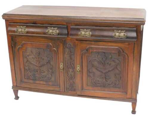 A late Victorian walnut sideboard, of rectangular form, the two frieze drawers set with heavy...