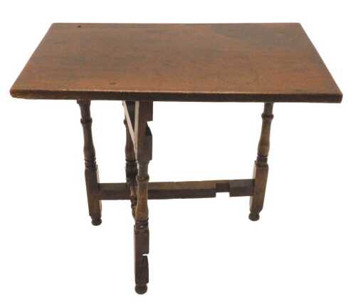 A 19thC rustic oak folding table, the rectangular top, on baluster legs terminating in orb feet,...