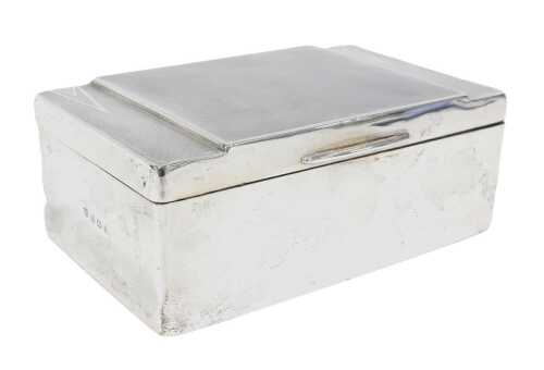 A George V Art Deco silver cigarette box, of oblong form, the hinged lid partially engine turned,...