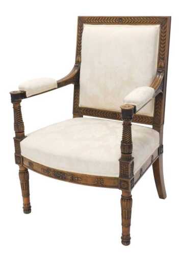 An early 20thC heavily carved oak carver chair, the back, arms and deep seat upholstered in a...