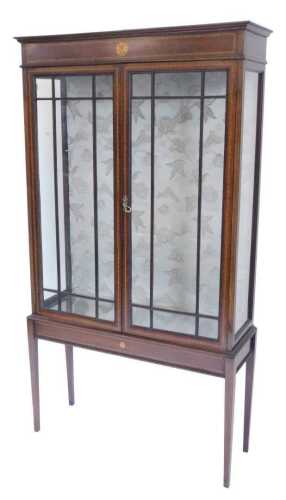 An Edwardian mahogany and boxwood strung display cabinet, of rectangular form, centred by a sun...