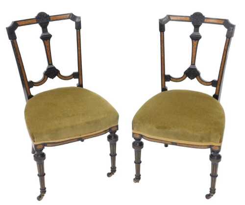 A pair of walnut and ebonised salon or dining chairs, each with shaped cresting rails, vertical...