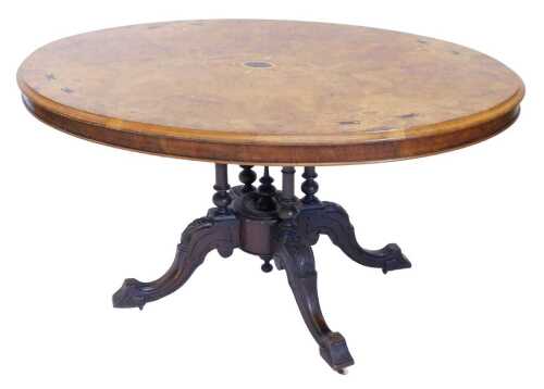 A Victorian walnut and inlaid tilt top loo table, the oval top inlaid with bell flowers and...