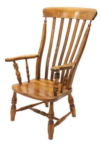 An early 20thC ash and elm grandfather chair, with comb top, vertical lath back, shaped arms, on...
