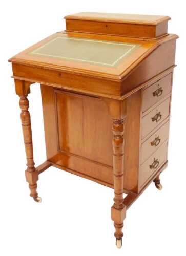 An Edwardian oak Davenport desk, the hinged upper opening revealing a fitted interior with...