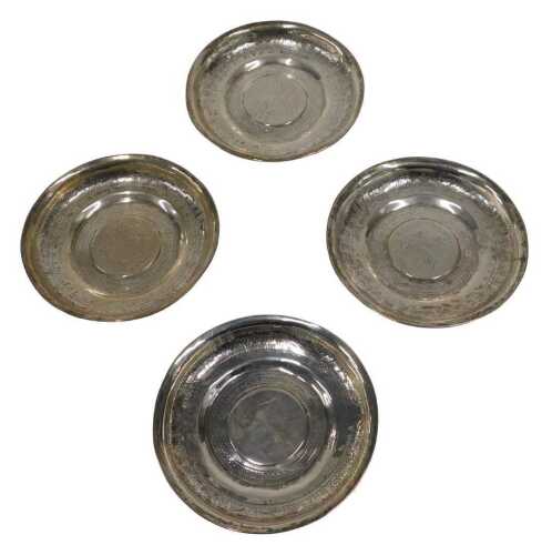 Four silver dishes, inset with European coins, to include Theresa style, unmarked white metal,...