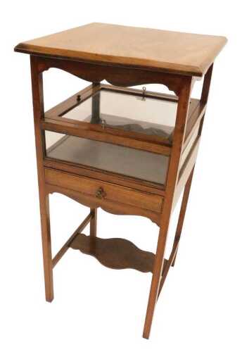 An unusual 19thC mahogany display and side table, the plain top raised above a glazed lockable...