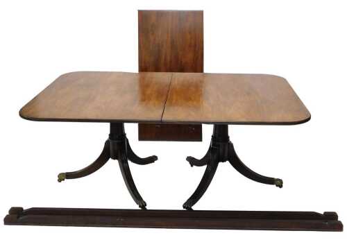 A Regency style mahogany twin pedestal D end dining table, with plain top, each pedestal with...