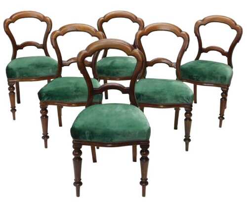 A set of six Victorian mahogany balloon back dining chairs, each with overstuffed seats, in...