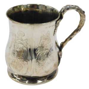 An early 20thC silver mug, of shaped bellied circular form, with leaf and bark handle, on...