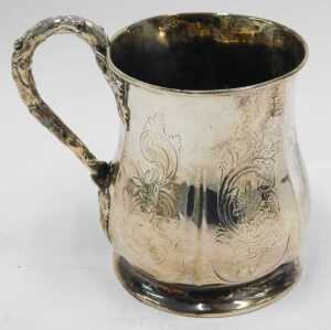 An early 20thC silver mug, of shaped bellied circular form, with leaf and bark handle, on... - 2