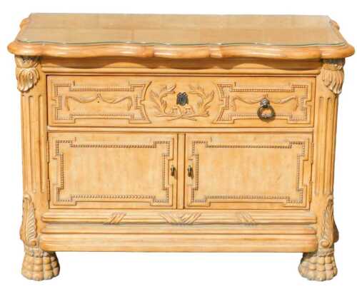 A late 20thC Regency style commode chest, the carved top raised above a heavily carved drawer,...