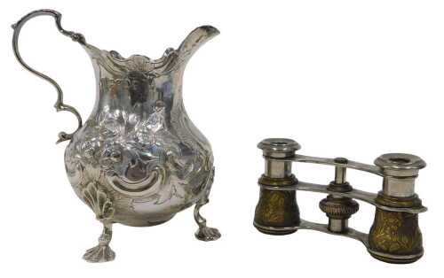 A Victorian silver cream jug, with flared rim, acanthus leaf ear handle, bulbous, repousse...