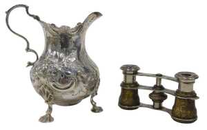 A Victorian silver cream jug, with flared rim, acanthus leaf ear handle, bulbous, repousse...