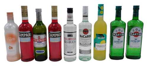 V - A bottle of Martini Extra Dry Vermouth, another similar, other bottles of spirits, Bacardi,...