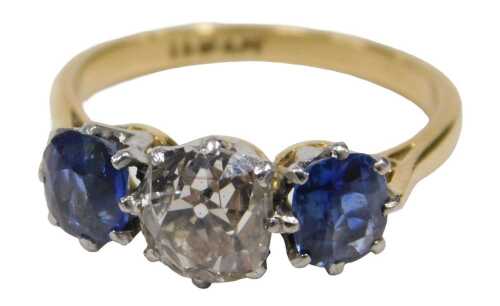 A diamond and sapphire three stone dress ring, with old cushion cut diamond, 6mm x 5.2mm x 4.4mm,...