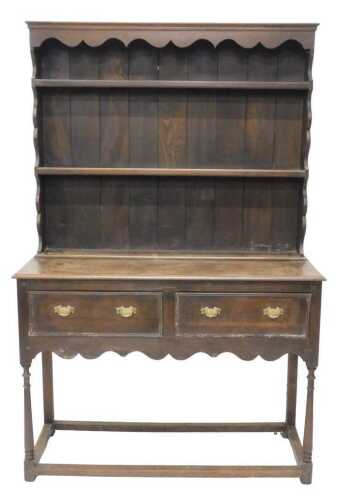 A 20thC oak kitchen dresser, with fixed cornice, raised above two Delft racks, the subsection...