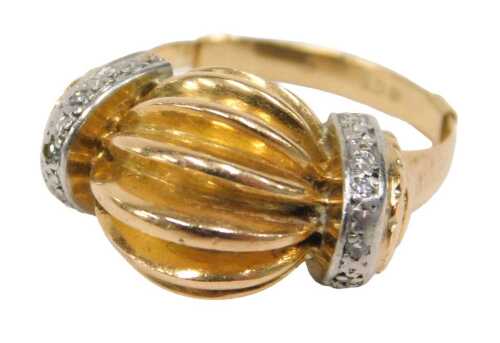 An abstract dress ring, the central bulbous stepped design flanked by tiny diamond set platinum...