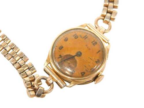 A Rex lady's wristwatch, with a copper finish numeric dial, in a yellow metal case, stamped 18k,...