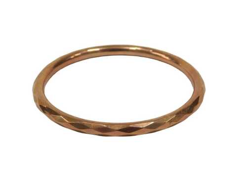 A 9ct rose gold bangle, of geometric hammered design, Chester, hallmarks rubbed, possibly 1929,...