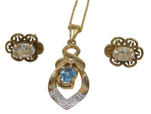 A necklace and earring matched set, comprising a 9ct gold blue topaz and diamond set pendant and...