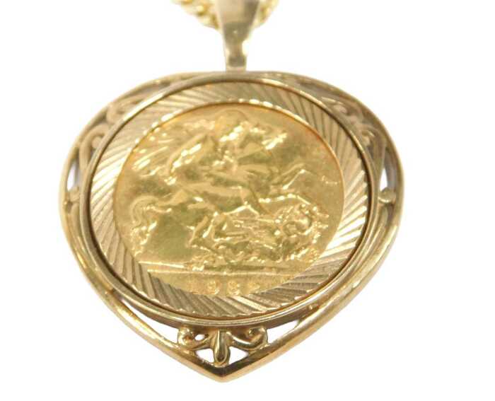 An Elizabeth II full gold sovereign pendant and chain, dated 1982, in 9ct gold heart shaped and...