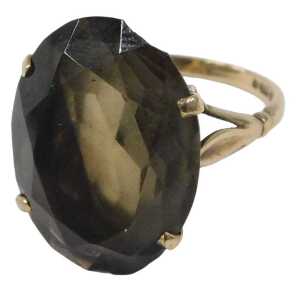 A 9ct gold smokey quartz dress ring, set with oval cut smokey quartz, in a raised four claw...