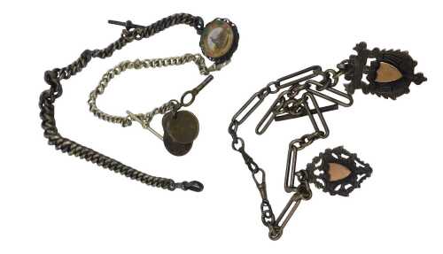 Three watch chains, comprising a silver figaro link chain with two shield crests, clips and T...