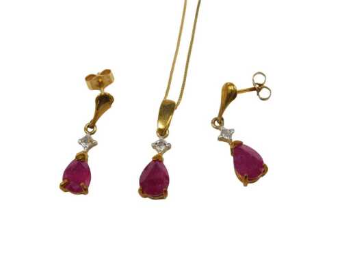 A diamond and ruby jewellery suite, comprising pendant and earrings, each of drop design with...