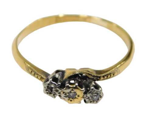 A three stone diamond twist ring, set with three old cut tiny diamonds, each claw set in...
