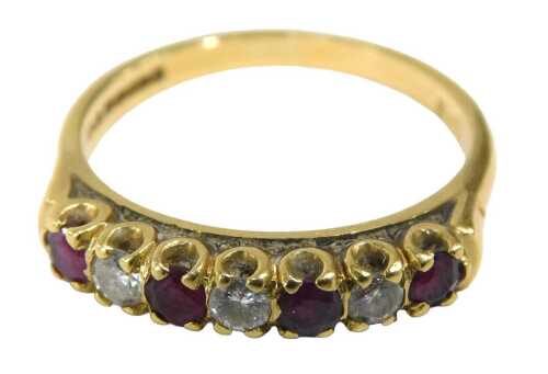 An 18ct gold ruby and diamond eternity ring, set with four round brilliant cut rubies and three...