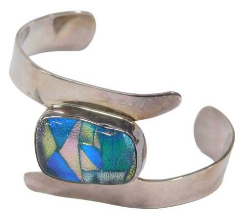A modern cuff bangle, the nugget shaped centre with metallic and glittered multicoloured pebble,...