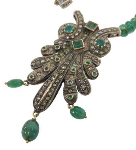 A 19thC emerald and diamond pendant, the nine point pendant set with old cut diamonds and round...