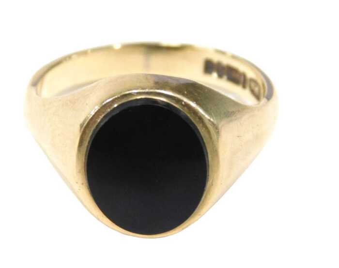A 9ct gold signet ring, the oval polished black jet ring head, on yellow metal band, by CPS,...