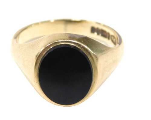 A 9ct gold signet ring, the oval polished black jet ring head, on yellow metal band, by CPS,...