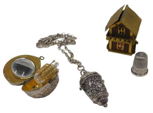 A group of 20thC curios, comprising a moulded brass and timber thimble case, formed as a house,...