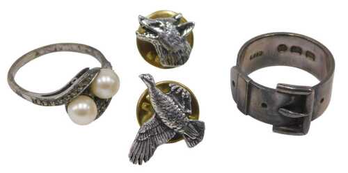 Four items of jewellery, comprising two silver dress rings, including an Edwardian buckle ring,...