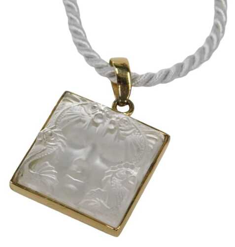A Lalique pendant and chain, the square set pendant depicting the Masque du Famille, of females...