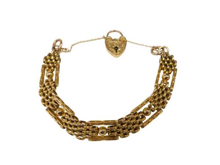 An elaborate gate bracelet, of four bar brushed design, with ball and bar links, with rose gold...