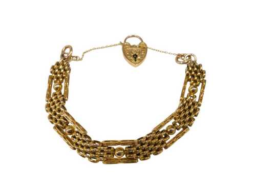 An elaborate gate bracelet, of four bar brushed design, with ball and bar links, with rose gold...